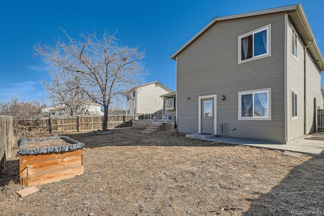 rear view of property with fence