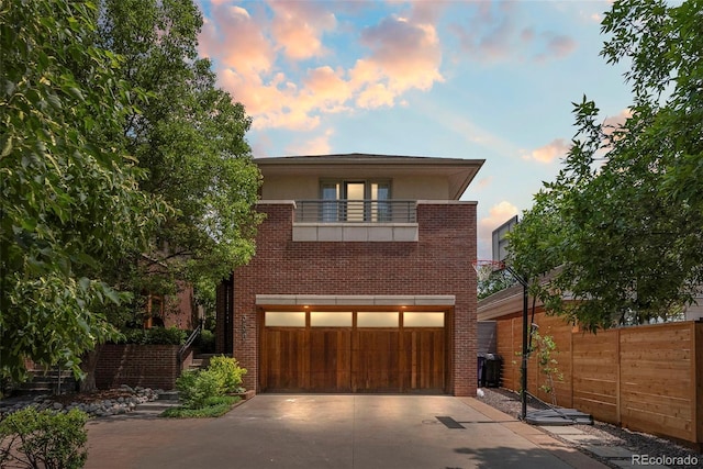 350 Holly St, Denver, CO 80220 - modern home featuring brick siding, an attached garage, a balcony, and concrete driveway