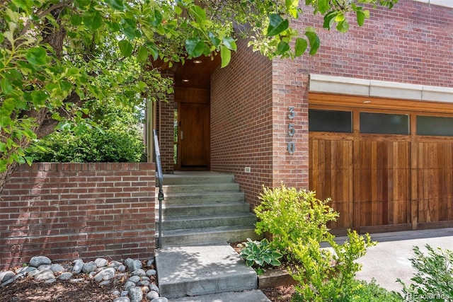 350 Holly St, Denver, CO 80220 - doorway to property with brick siding and a garage