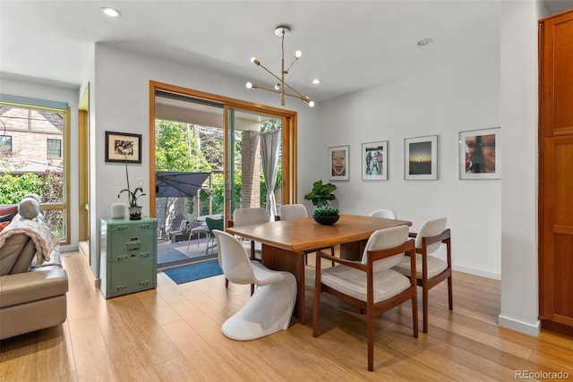 350 Holly St, Denver, CO 80220 - dining room with light wood finished floors, a chandelier, recessed lighting, and baseboards