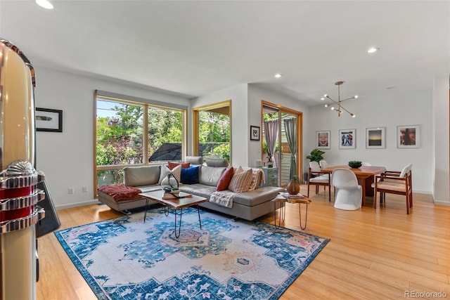 350 Holly St, Denver, CO 80220 - living room with light wood finished floors, a chandelier, recessed lighting, and baseboards