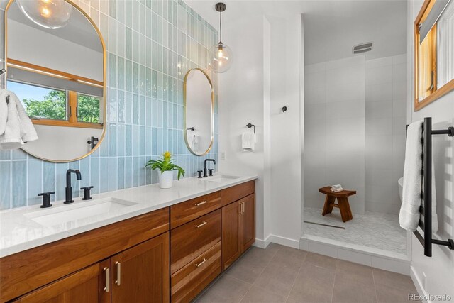 350 Holly St, Denver, CO 80220 - bathroom with tile patterned floors, double vanity, tile walls, backsplash, and baseboards