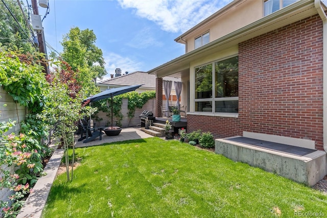 350 Holly St, Denver, CO 80220 - view of grassy yard with a patio and a fire pit