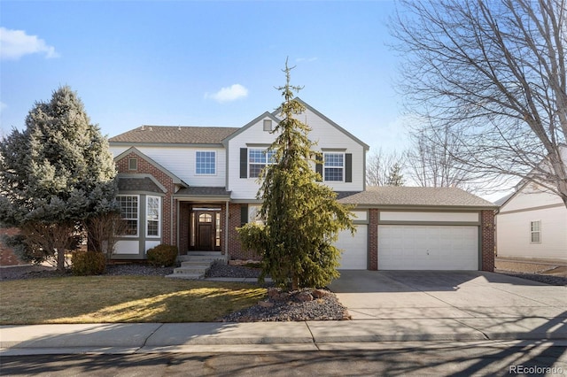 traditional-style house featuring a front lawn, concrete driveway, brick siding, and an attached garage