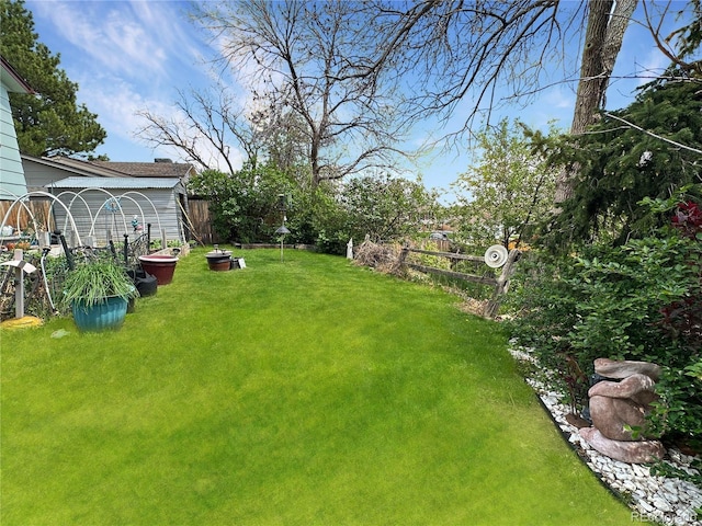 view of yard with a garden and fence