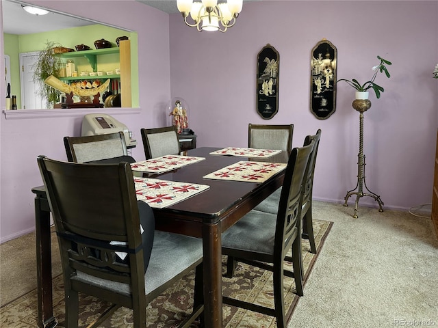 carpeted dining space with baseboards and a chandelier