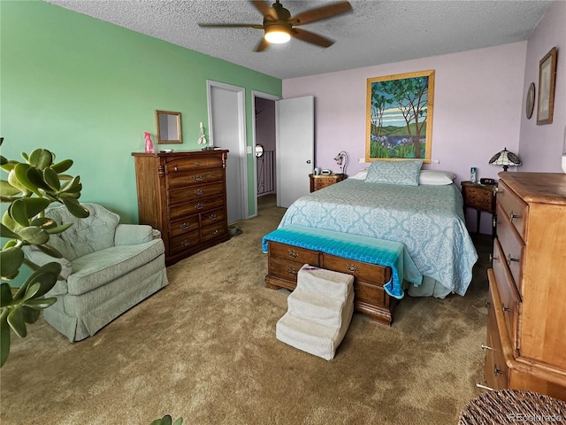 bedroom featuring carpet floors, a ceiling fan, and a textured ceiling