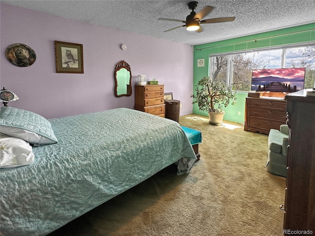 bedroom with carpet floors, ceiling fan, and a textured ceiling
