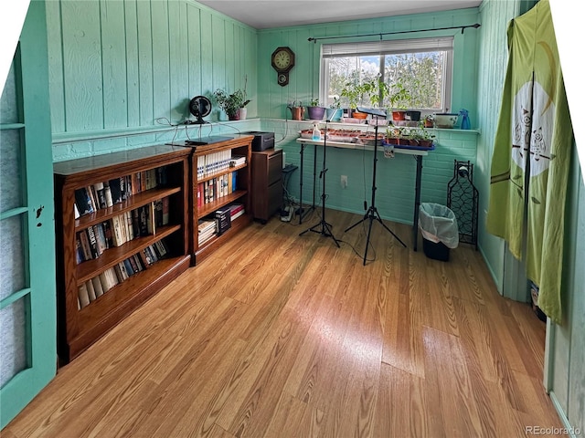 office space featuring wooden walls and wood finished floors