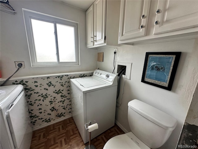 washroom featuring laundry area, baseboards, a wainscoted wall, and washing machine and clothes dryer
