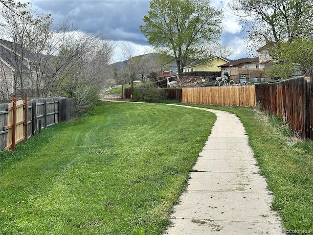 view of yard with a mountain view and fence private yard