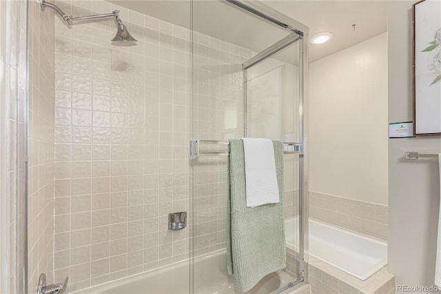 bathroom featuring shower / bath combination with glass door