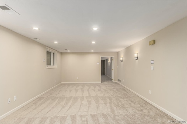 unfurnished room with visible vents, recessed lighting, baseboards, and light carpet