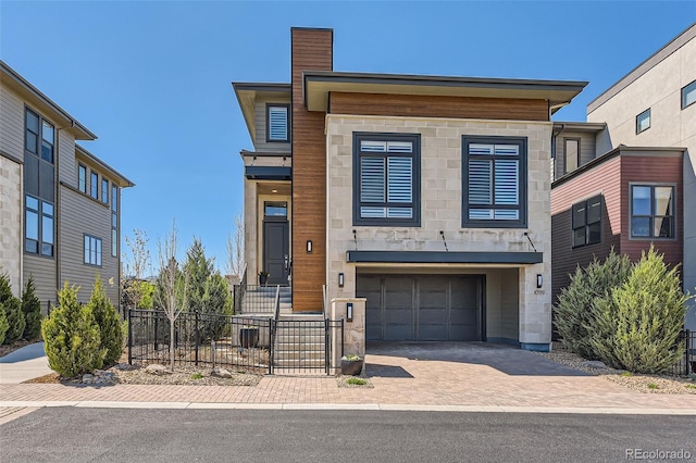 10119 Bellwether Ln, Lone Tree, CO 80124 - view of front of house featuring fence, stone siding, a chimney, an attached garage, and driveway