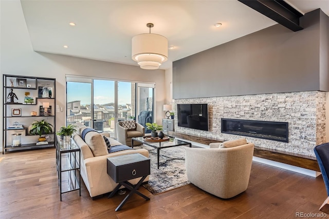 10119 Bellwether Ln, Lone Tree, CO 80124 - living room with recessed lighting, beam ceiling, a stone fireplace, and wood finished floors
