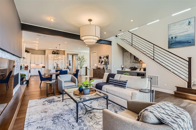 10119 Bellwether Ln, Lone Tree, CO 80124 - living room featuring recessed lighting, baseboards, wood finished floors, visible vents, and stairway