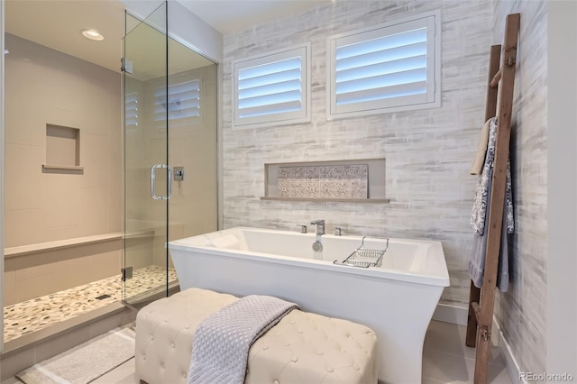 10119 Bellwether Ln, Lone Tree, CO 80124 - bathroom with tile patterned floors, a freestanding bath, a stall shower, and tile walls