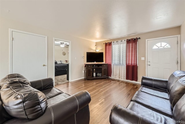 living area featuring baseboards and wood finished floors