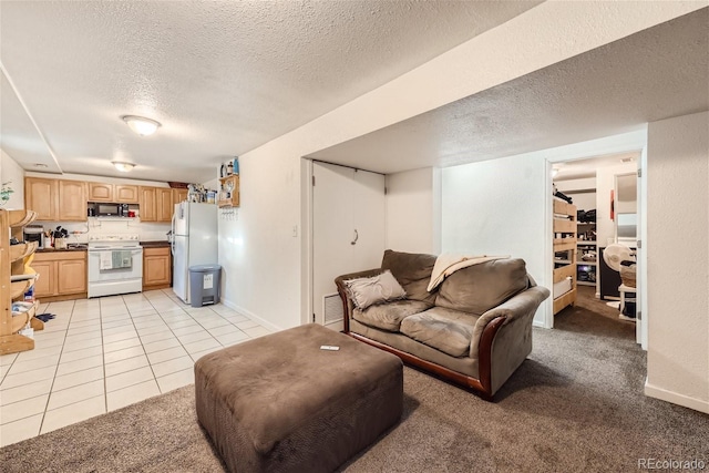 465 Miller Ave, Brighton, CO 80601 - living room featuring light tile patterned floors, baseboards, visible vents, light colored carpet, and a textured ceiling