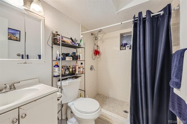 465 Miller Ave, Brighton, CO 80601 - bathroom with a textured wall, toilet, a textured ceiling, a shower stall, and vanity