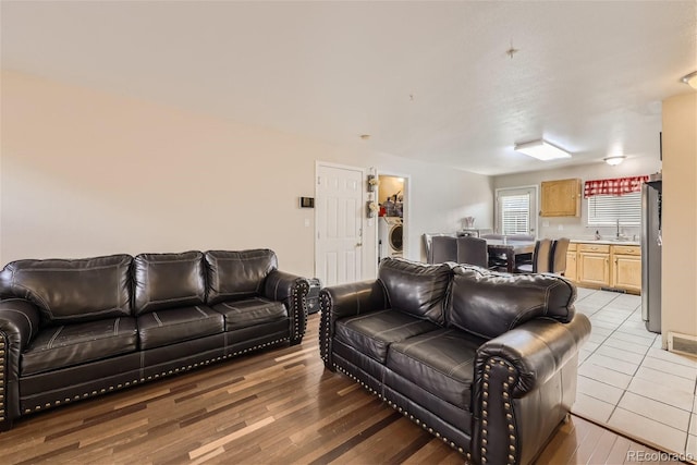 465 Miller Ave, Brighton, CO 80601 - living room featuring washer / dryer and light wood-style flooring