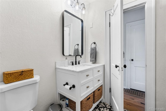 half bath featuring toilet and vanity