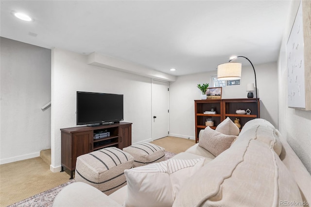 living area with recessed lighting, light colored carpet, and baseboards