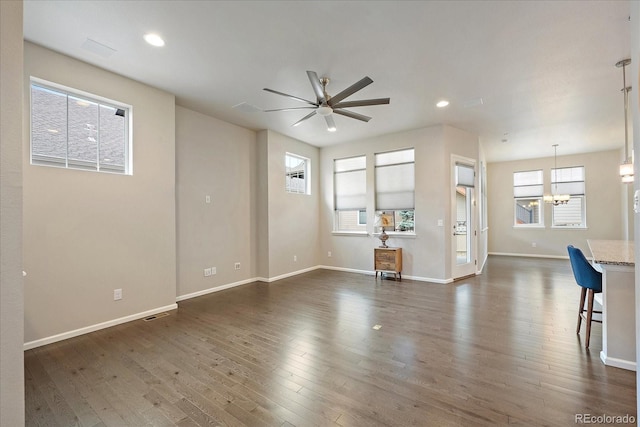 3336 Goodyear St, Castle Rock, CO 80109 - unfurnished living room with ceiling fan, a chandelier, dark wood-type flooring, and recessed lighting