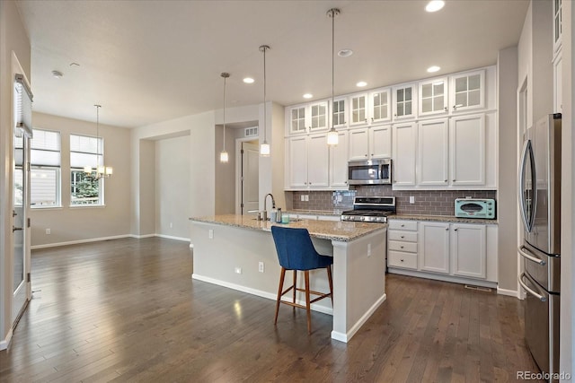 3336 Goodyear St, Castle Rock, CO 80109 - kitchen with appliances with stainless steel finishes, white cabinets, tasteful backsplash, a chandelier, and recessed lighting