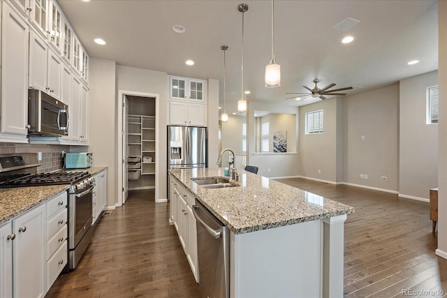 3336 Goodyear St, Castle Rock, CO 80109 - kitchen featuring stainless steel appliances, dark wood-style flooring, an island with sink, ceiling fan, and white cabinets