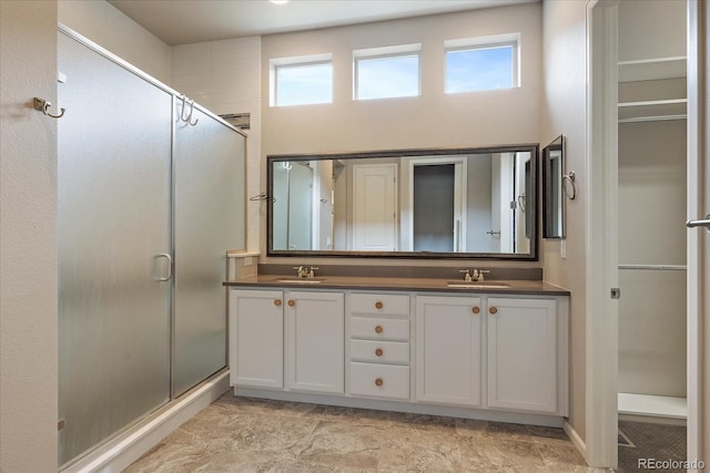 3336 Goodyear St, Castle Rock, CO 80109 - bathroom with healthy amount of natural light, a stall shower, and double vanity