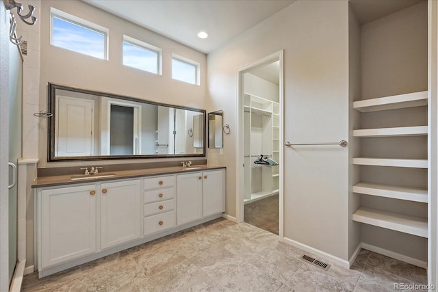3336 Goodyear St, Castle Rock, CO 80109 - bathroom with a walk in closet and double vanity