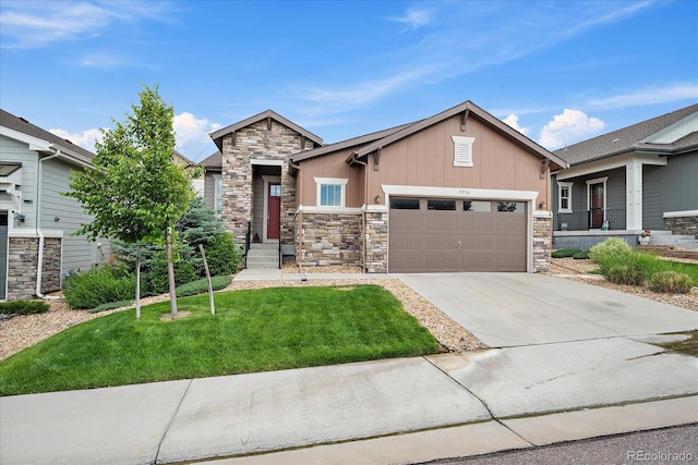 3336 Goodyear St, Castle Rock, CO 80109 - craftsman-style home with stone siding, concrete driveway, an attached garage, a front yard, and board and batten siding