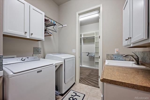 3336 Goodyear St, Castle Rock, CO 80109 - laundry area with cabinet space, washer and clothes dryer, and light tile patterned flooring