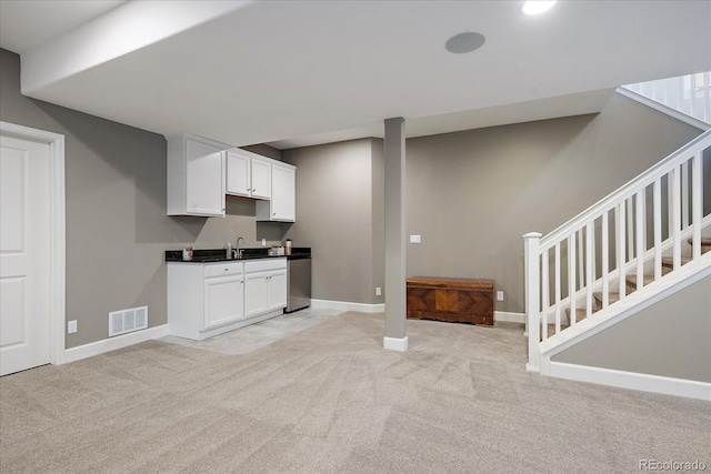 3336 Goodyear St, Castle Rock, CO 80109 - kitchen featuring light colored carpet, white cabinetry, dark countertops, and dishwasher