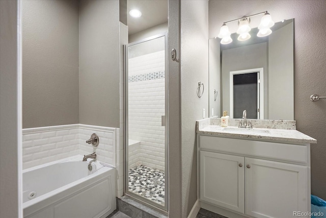 3336 Goodyear St, Castle Rock, CO 80109 - full bathroom with a bath, a shower stall, vanity, and a textured wall