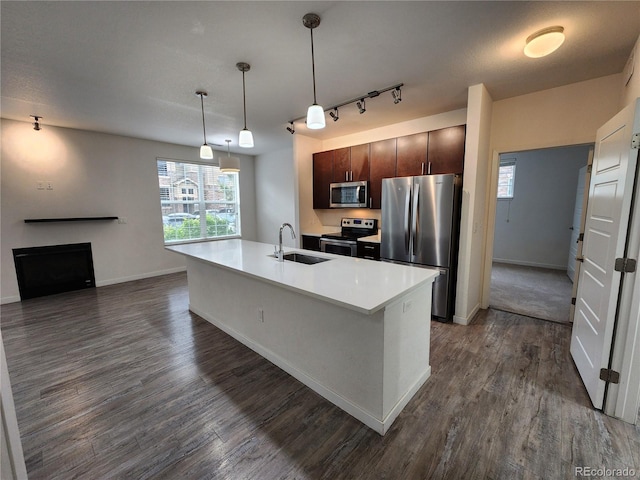 9220 Wilde Ln Unit 102, Parker, CO 80134 - kitchen with stainless steel appliances, a sink, dark wood finished floors, light countertops, and baseboards