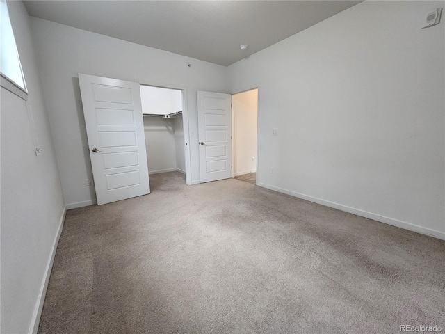 9220 Wilde Ln Unit 102, Parker, CO 80134 - unfurnished bedroom with light colored carpet, baseboards, and a closet