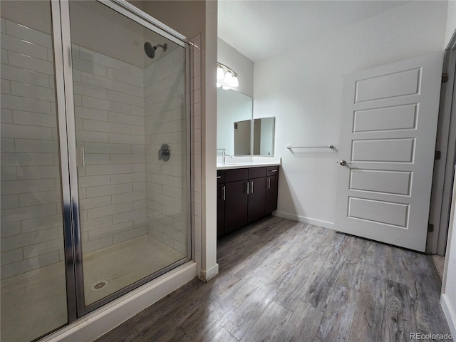 9220 Wilde Ln Unit 102, Parker, CO 80134 - bathroom with a shower stall, vanity, wood finished floors, and baseboards
