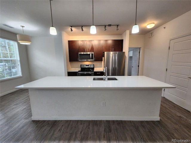 9220 Wilde Ln Unit 102, Parker, CO 80134 - kitchen with stainless steel appliances, a sink, track lighting, and dark wood-style flooring