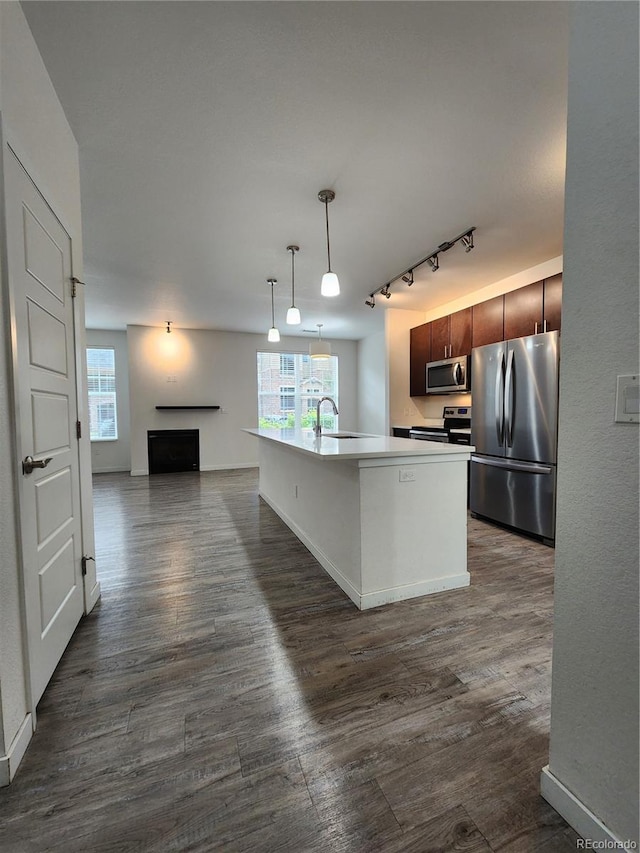 9220 Wilde Ln Unit 102, Parker, CO 80134 - kitchen with stainless steel appliances, dark wood-style flooring, track lighting, and plenty of natural light