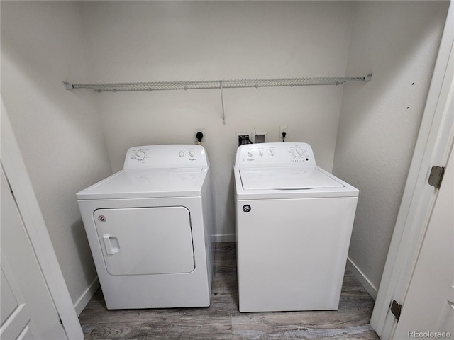 9220 Wilde Ln Unit 102, Parker, CO 80134 - laundry room featuring washing machine and clothes dryer, wood finished floors, and baseboards