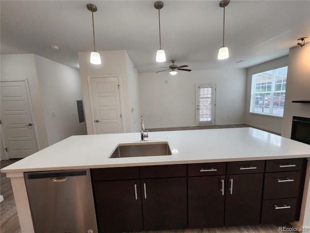 9220 Wilde Ln Unit 102, Parker, CO 80134 - kitchen with stainless steel dishwasher, a sink, open floor plan, a ceiling fan, and light countertops