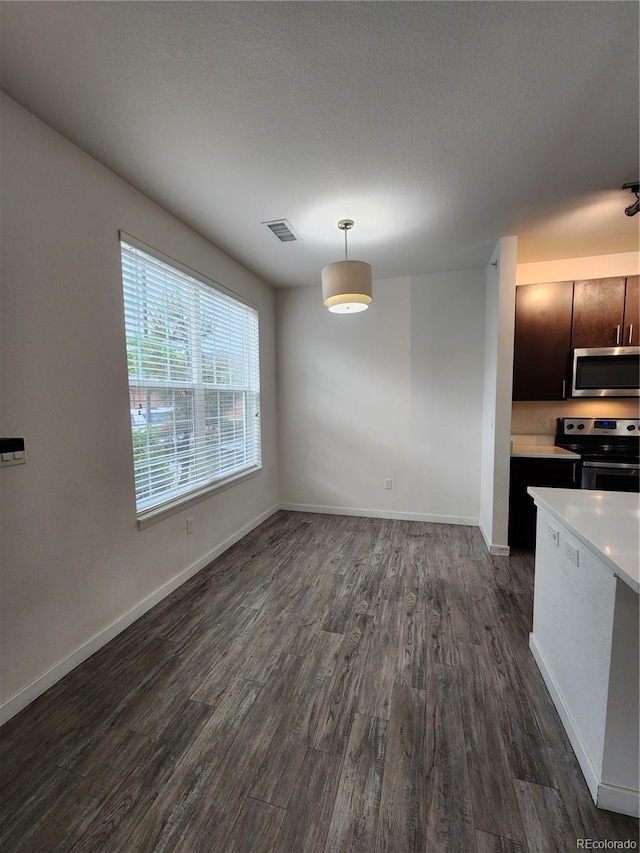 9220 Wilde Ln Unit 102, Parker, CO 80134 - kitchen with stainless steel appliances, dark wood-type flooring, light countertops, and baseboards