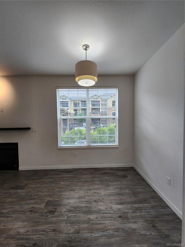 9220 Wilde Ln Unit 102, Parker, CO 80134 - unfurnished dining area featuring dark wood finished floors and baseboards