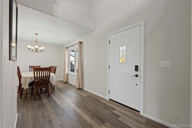 entryway featuring dark hardwood / wood-style flooring and an inviting chandelier