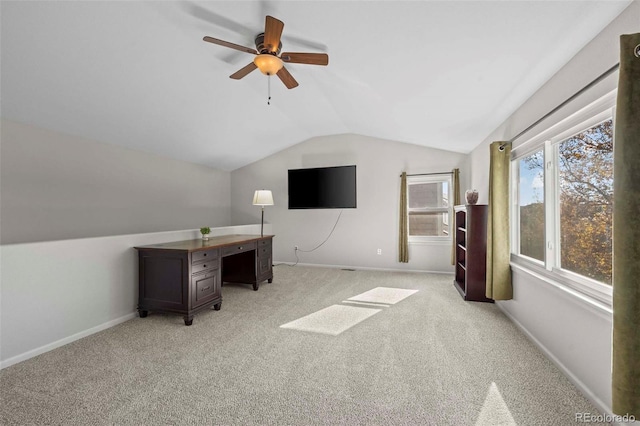 unfurnished office featuring ceiling fan, light colored carpet, and vaulted ceiling