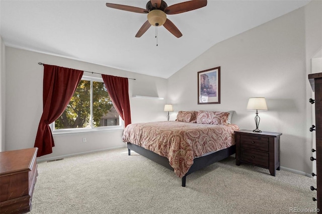 carpeted bedroom with vaulted ceiling and ceiling fan