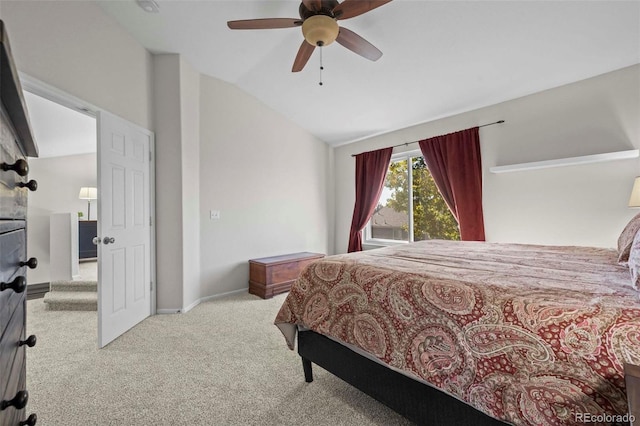 carpeted bedroom with ceiling fan and vaulted ceiling