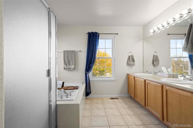 bathroom featuring plus walk in shower, tile patterned flooring, and vanity